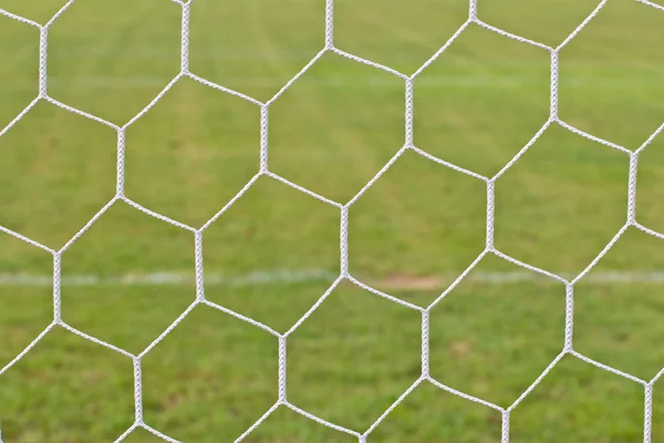 Background of football net on a green grass — Stock Photo, Image