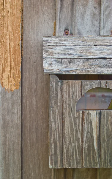 Vintage grungy letter box on wooden door — Stock Photo, Image
