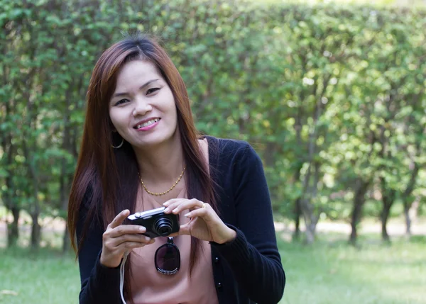 Beautiful young woman taking photos outdoors — Stock Photo, Image
