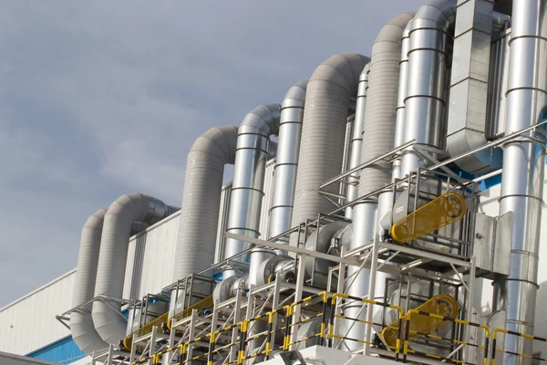 Pipes on exterior of modern factory building. — Stock Photo, Image