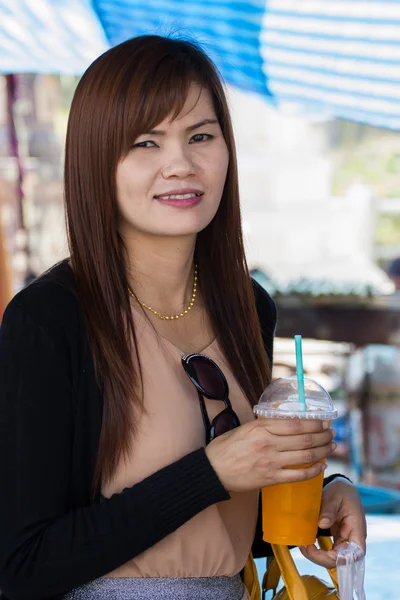 Young attractive woman with a glass of orange juice — Stock Photo, Image