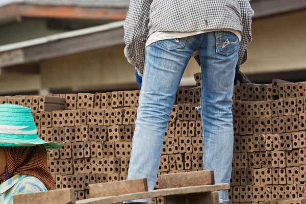 Mujer trabajador está dislocando un ladrillo de producción de ladrillos en —  Fotos de Stock