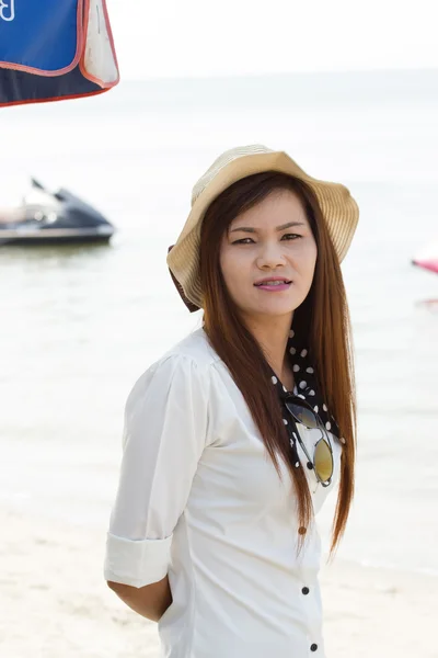 Aziatische vrouw in mooie hoed op tropisch strand — Stockfoto