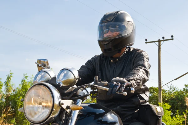 View of a man with a motorcycle on a asphalt road. — Stock Photo, Image