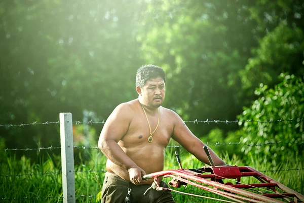 Thai farmer on small tractor — Stock Photo, Image