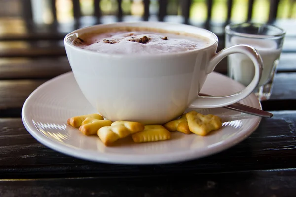 Hot coffee on wooden table — Stock Photo, Image