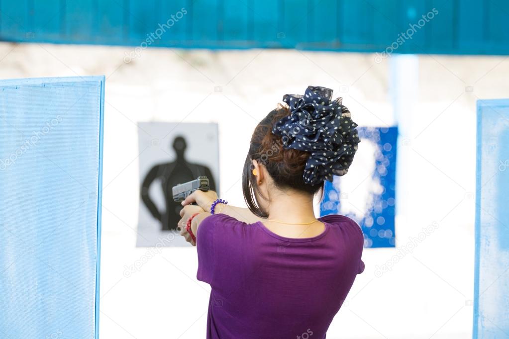 Target practicing with gun In the shooting range