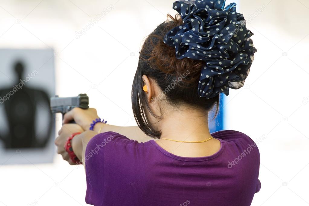 Target practicing with gun In the shooting range