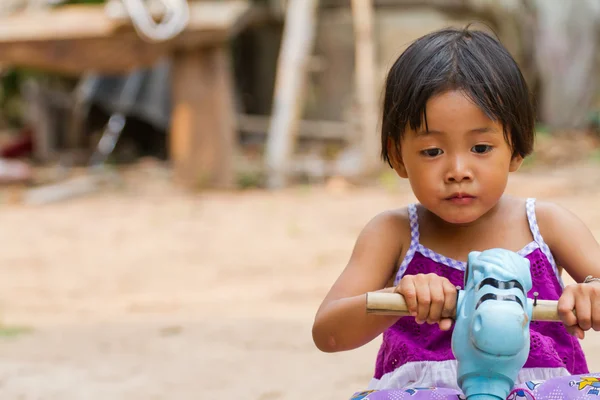 Little girl playing on  toy car — Stock Photo, Image