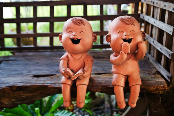 two statuettes of funny boy and girl 