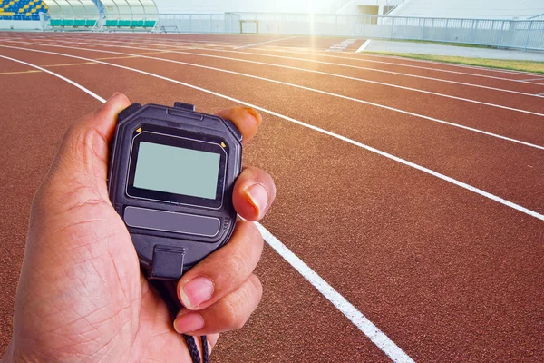 Close-up of  man holding  stopwatch to measure performances of t — Stock Photo, Image