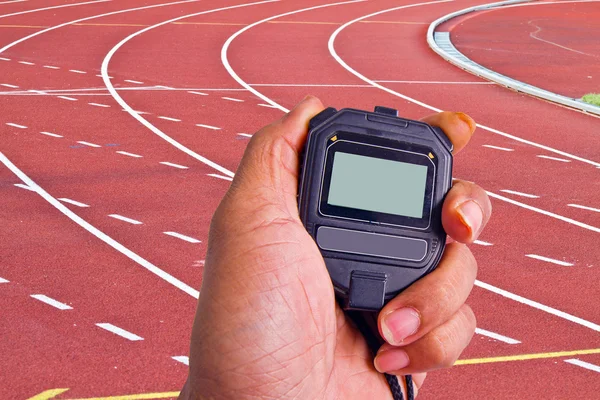 Close-up of  man holding  stopwatch to measure performances of t — Stock Photo, Image