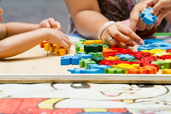 Hand child playing with construction blocks