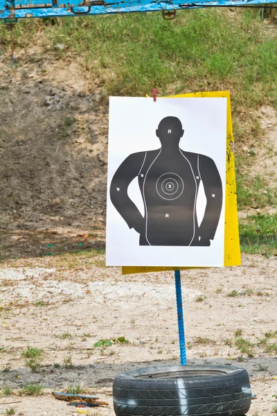 Hand with gun shooting target — Stock Photo, Image