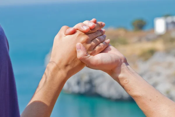 Man and woman hands touch in gentle, soft way on blue sunny sky. — Stock Photo, Image