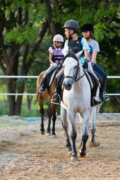 Child trains horse riding , — Stock Photo, Image