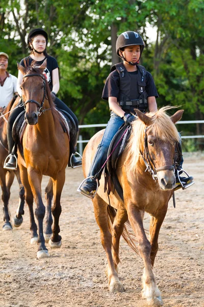 Child trains horse riding , — Stock Photo, Image