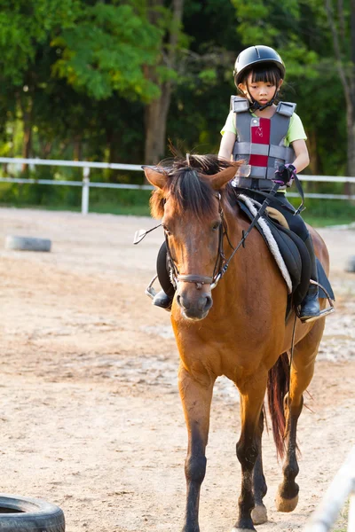 Child trains horse riding , — Stock Photo, Image