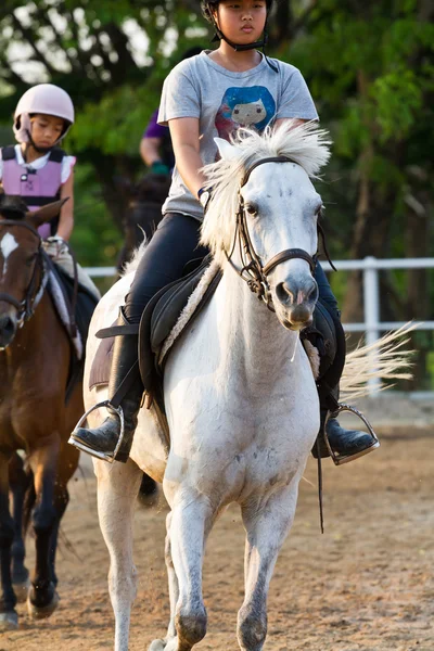 Child trains horse riding , — Stock Photo, Image