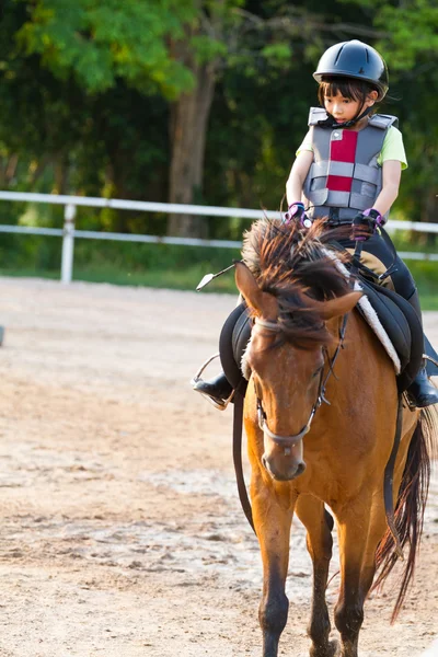 Child trains horse riding , — Stock Photo, Image