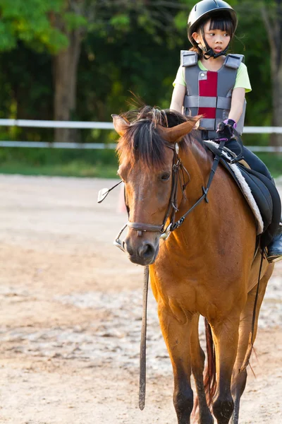 Child trains horse riding , — Stock Photo, Image