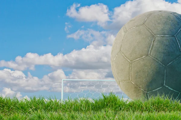 Old used football or soccer ball on cracked asphalt — Stock Photo, Image