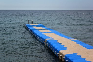 Floating plastic pier at the seashore