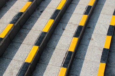 Stone steps with black and yellow warning stripes
