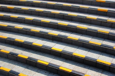 Stone steps with black and yellow warning stripes