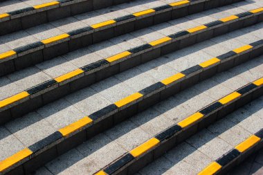 Stone steps with black and yellow warning stripes