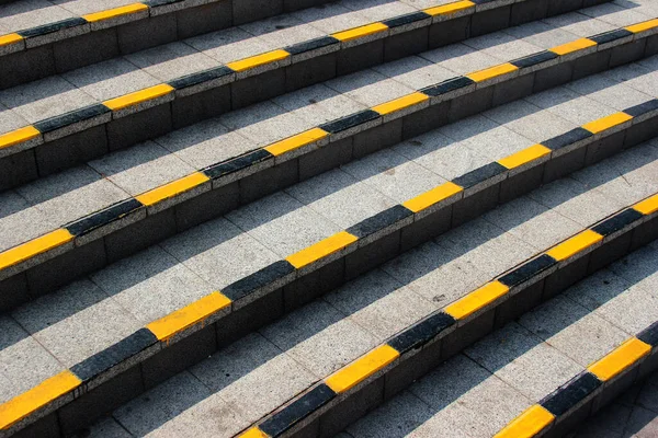 Stone steps with black and yellow warning stripes