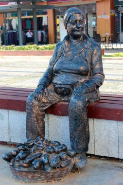 Antalya, Turkey - August 22, 2022: Statue of an old woman selling eggplants on Ali Cetinkaya street in central part of Antalya