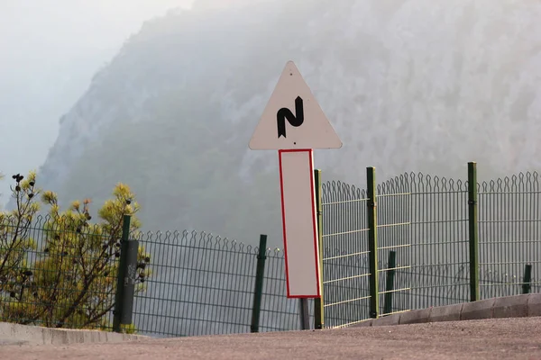 Road Sign Mountains Warning Winding Road Ahead — Stockfoto