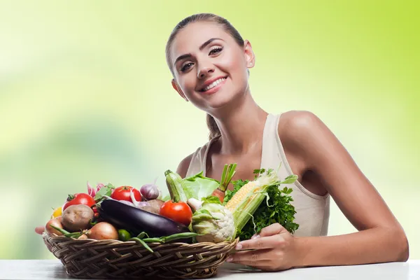 Woman holding basket with vegetable. Concept vegetarian dieting 스톡 사진