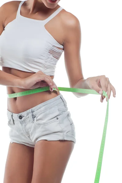 Woman in perfect shape with green measure doing yoga poses. — Stock Photo, Image