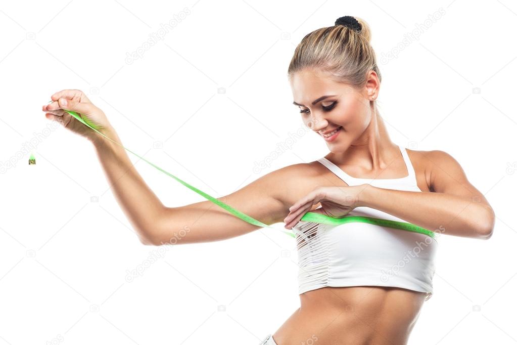 Woman in perfect shape with green measure doing yoga poses.