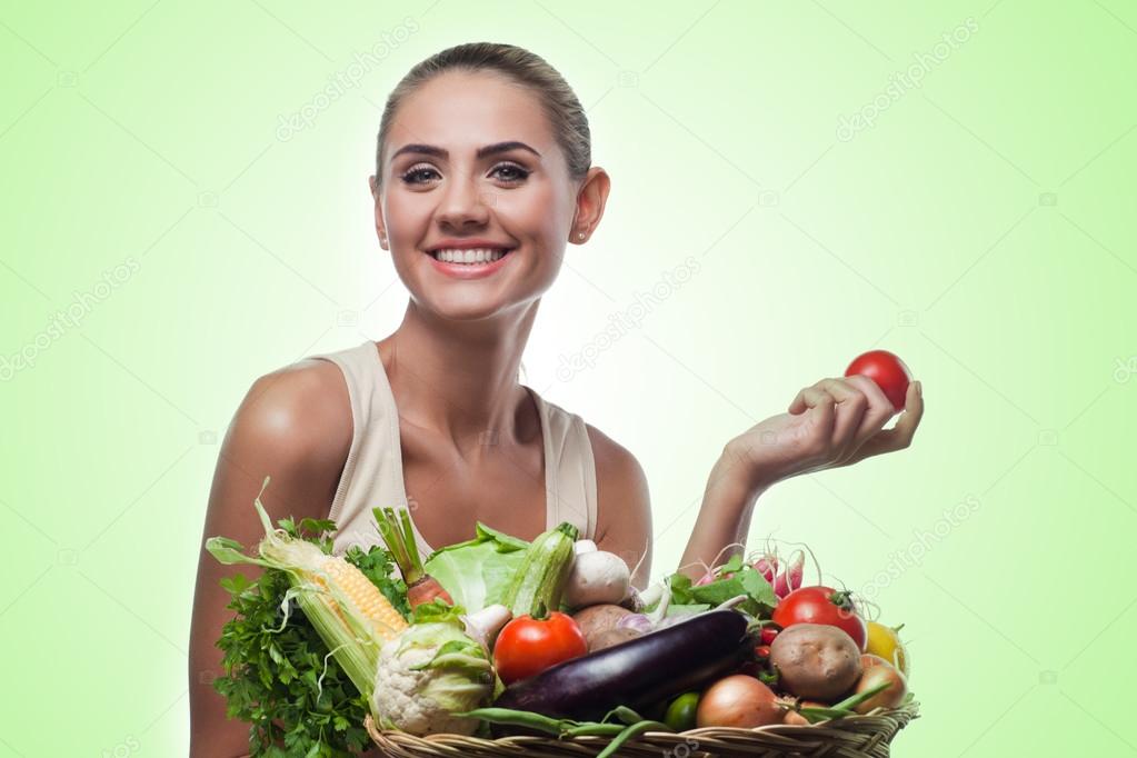 Woman holding basket with vegetable. Concept vegetarian dieting