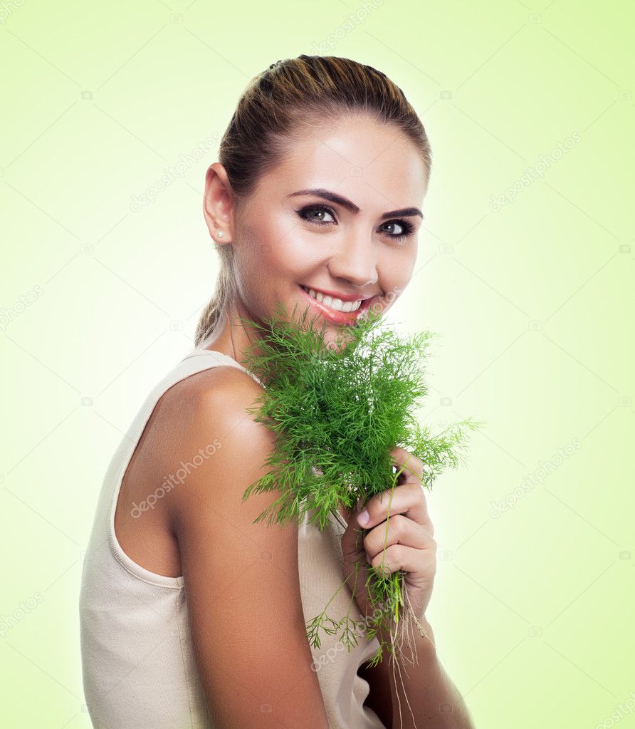 Woman with bundle herbs (salad). Concept vegetarian dieting