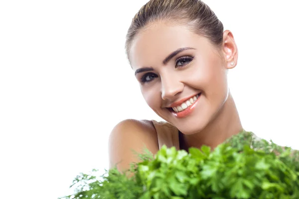 Close-up portrait of happy young woman with bundle herbs (salad) in hands. Stock Photo