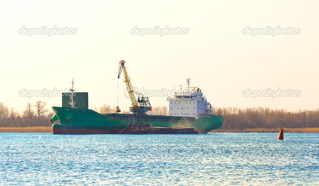 The cargo vessel on the river