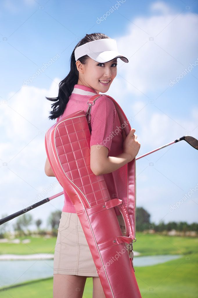 Woman carrying golf bag — Stock Photo © ViewStock 36537221