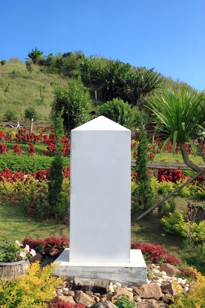 Milestone on the road with mountain and blue sky background — Stock Photo, Image