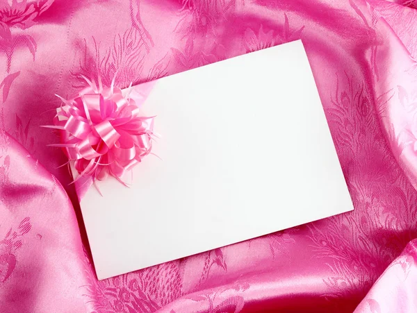 Blank gift card on pink satin — Stock Photo, Image