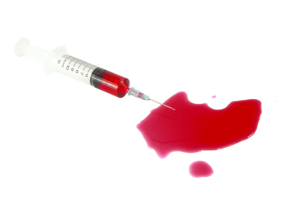 Syringe with blood on a white background — Stock Photo, Image