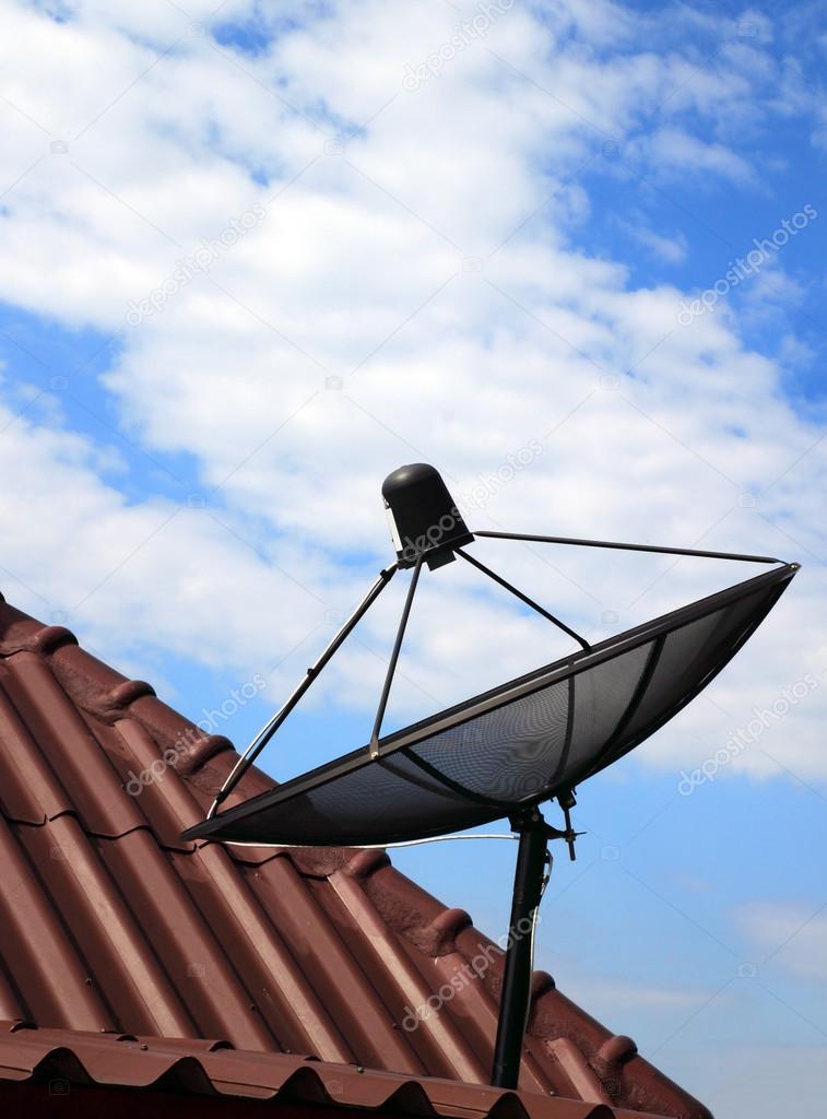 black satellite dish on house roof