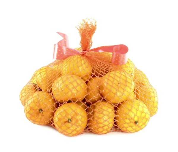 A bunch of oranges packaged in netting, isolated on white — Stock Photo, Image