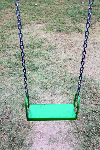 Green garden swing hanging in garden — Stock Photo, Image