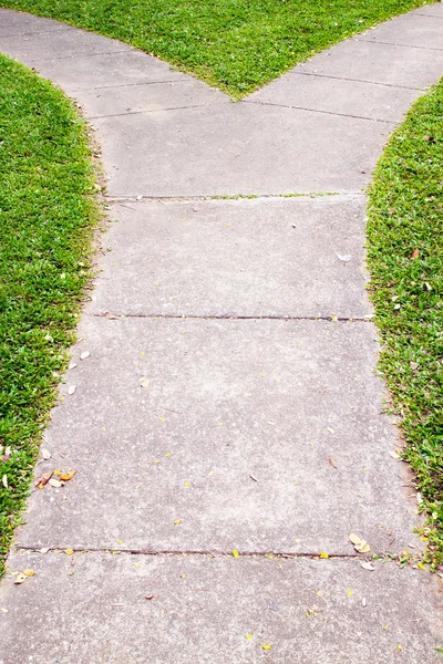 Fork in the pathway with grass — Stock Photo, Image