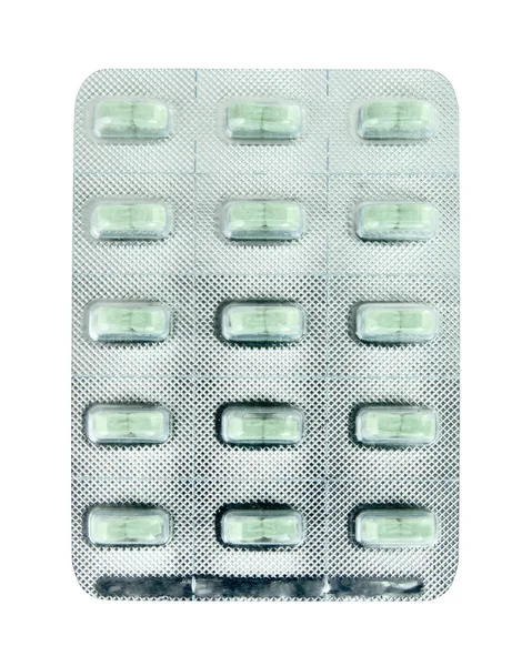 Pacote de pílulas verdes no branco — Fotografia de Stock