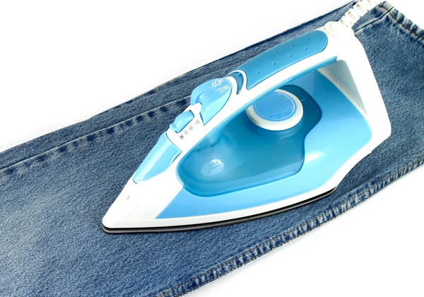 Ironing jeans on a white baclground — Stock Photo, Image